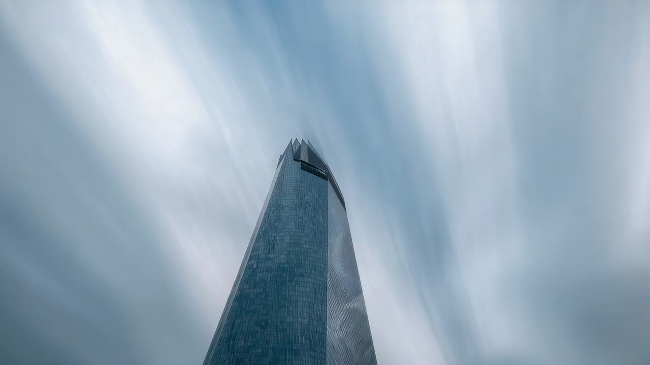 Starting camera low filming centered tower showing facade and crown, radial clouds from street