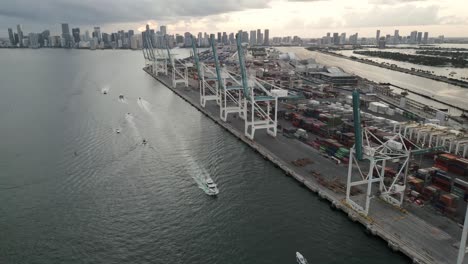 miami commercial port south beach downtown skyline cityscape at sunset drone fly above crane cargo container boat