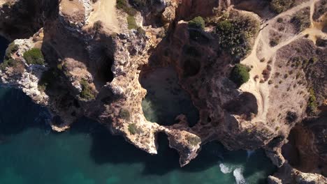 top down of eroded out giant rock pools and caves off of ponta da piedade, lagos, portugal