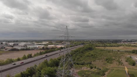 powerlines over m50 motorway in dublin, ireland on a cloudy weather - aerial shot