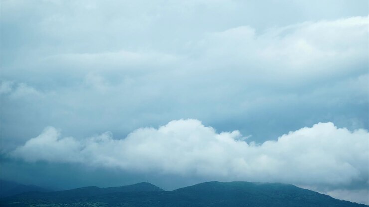 4k uhd seamless loopable time lapse of clouds movement on dramatic sky with mountains and hills