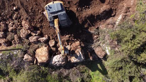 Crawler-Bucket-Making-Walls-Out-Of-Rocks