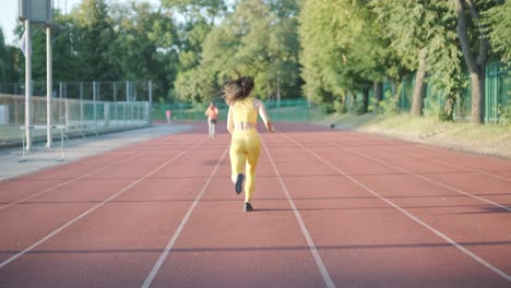 woman jogging on outdoor track in sportswear at athletic field