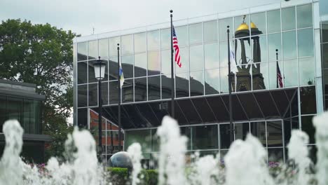 water fountains spraying water outside of an office building in boston, massachusetts in slow motion