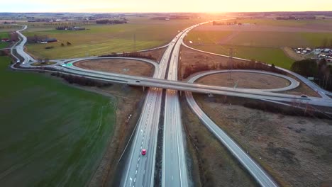 aerial view of freeway intersection with moving traffic cars.