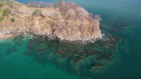 Costa-Rica-Beach-Headland-Overlooking-Scenic-Blue-Ocean,-4K-Drone-Flyover