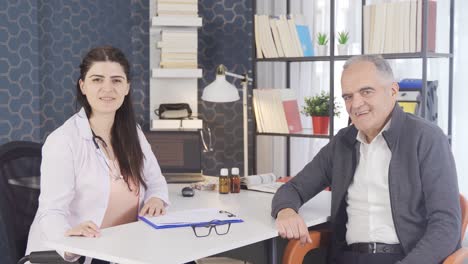 Positive-female-doctor-and-her-patient-smiling-at-camera.