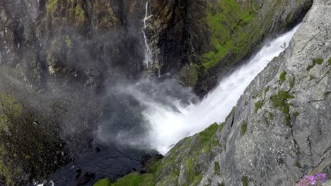 slow motion view down voringfossen and canyon, panning across valley as river flows through mabodalen towards eidfjord