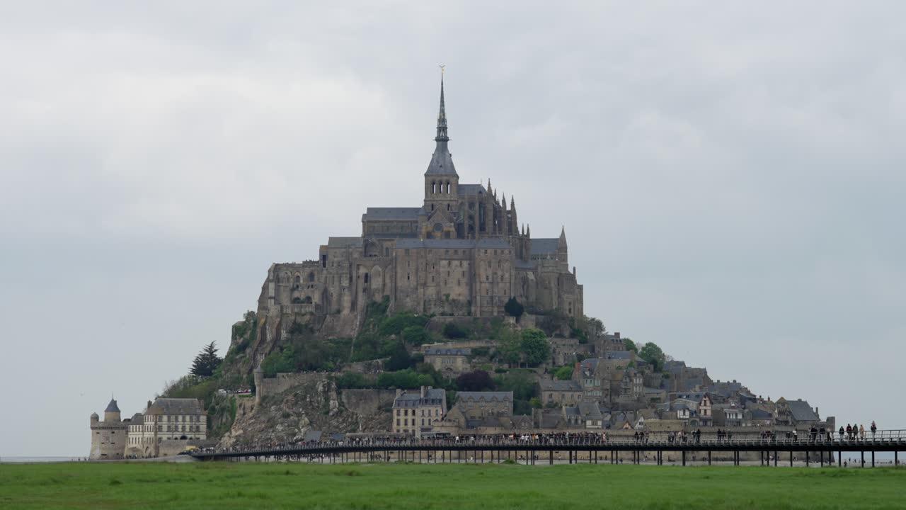 SLOW MOTION STATIC HANDHELD SHOT OF MOUNT SAINT MICHELE IN NORMANDY AT A CLOUDY DAY