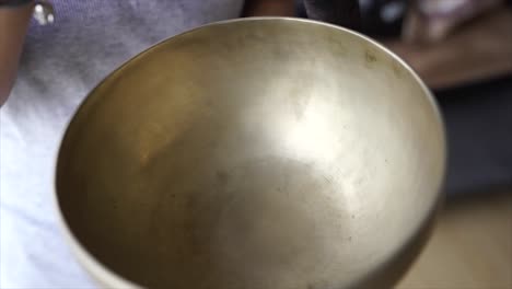 female playing the tibetan bowl