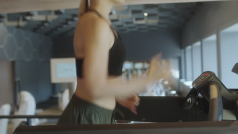 sporty woman running on treadmill
