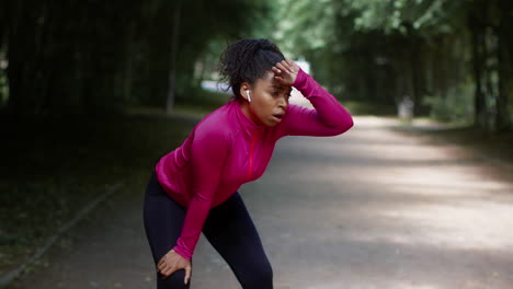 woman taking a break after running in the park