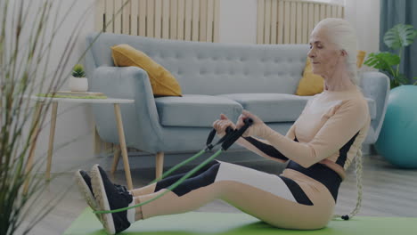 senior woman doing resistance band exercises at home