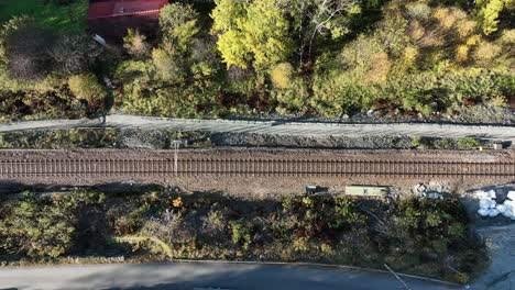 sideways moving birdseye aerial above railway tracks, norway