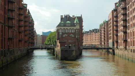 aug 2020, hamburg, germany: zoom out view of the river from the famous speicherstadt, a unesco world heritage site of the maritime history of the city