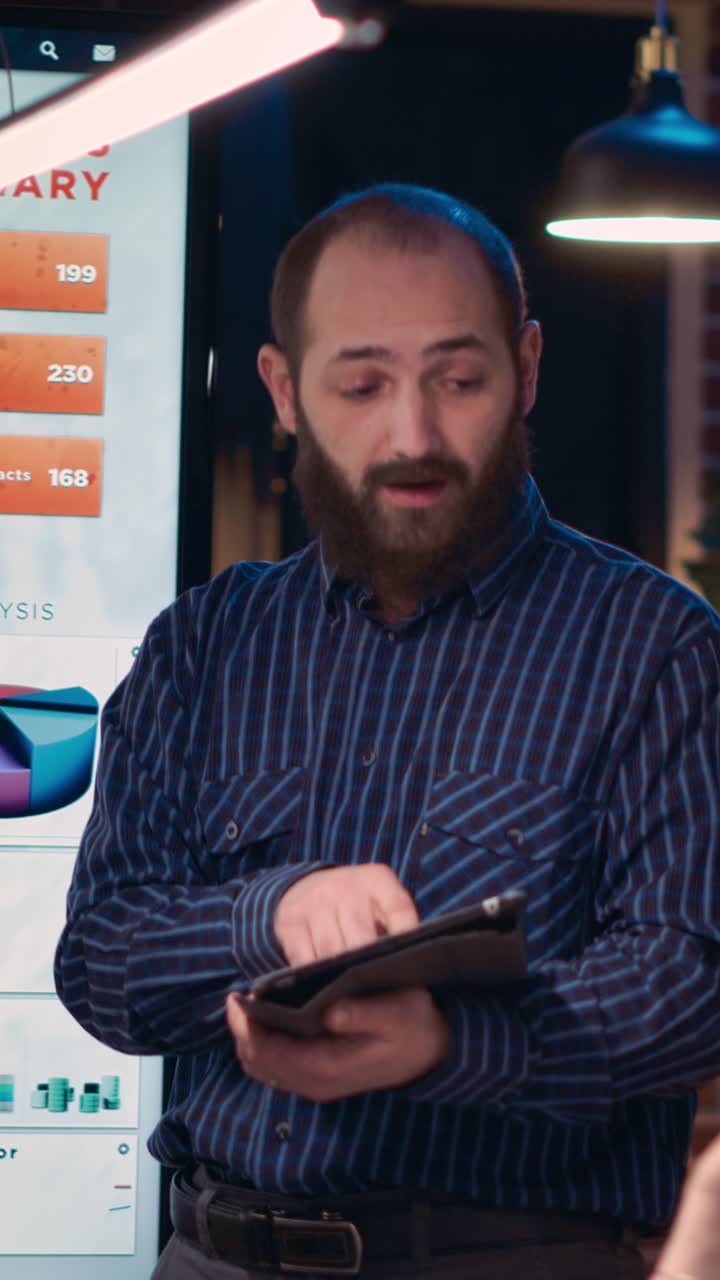 Vertical video: Company analyst explaining statistics, giving presentation in business meeting