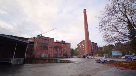 Modern-apartment-building-and-a-chimney-on-the-yard-of-an-old-factory-district