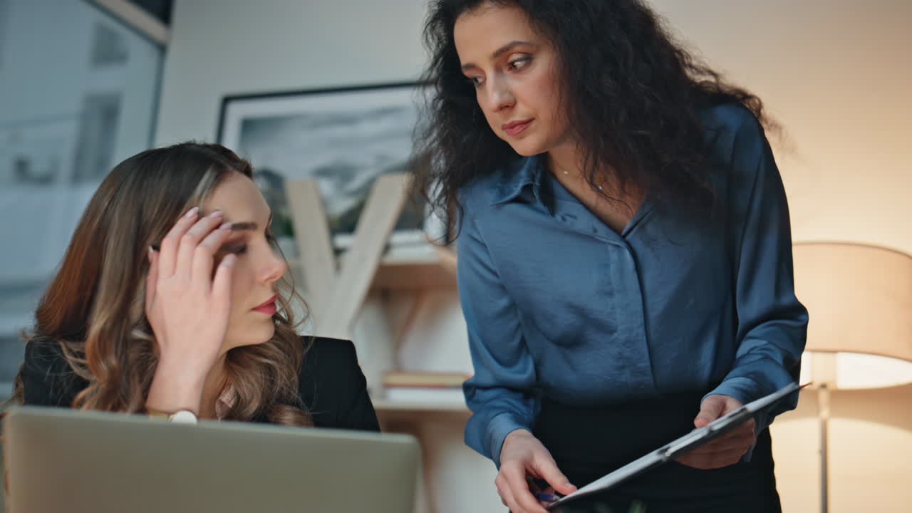 Business mentor explaining woman report in evening office. Closeup team members