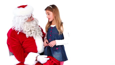 little girl telling santa what she wants for christmas