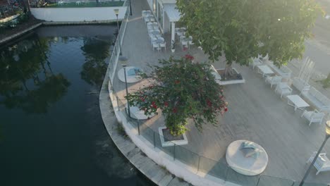 Drone-aerial-pan-of-outdoor-patio-dining-courtyard-with-tables-chairs-seating-furniture-travel-tourism-cafe-culture-Mallorca-Spain-Europe