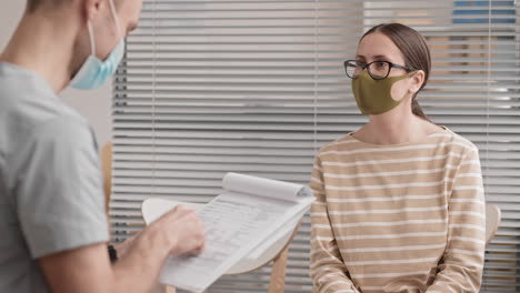 doctor checking medical history with patient