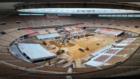 vehicles dig and transport earth in sevilla stadium renovation