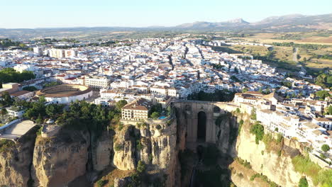 AERIAL---Epic-view-of-the-town-of-Ronda,-Malaga,-Spain,-landscape-shot-lowering