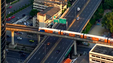 sathorn road and intersection in transportation concept, bts skytrain at sunset, bangkok, thailand