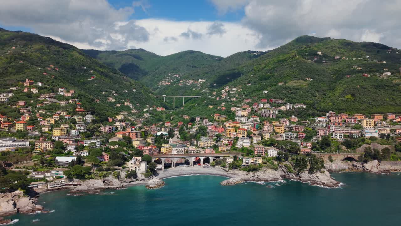 A picturesque italian coastal town nestled between lush green hills and the mediterranean sea, aerial view