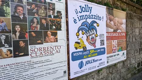 various posters on a brick wall in sorrento