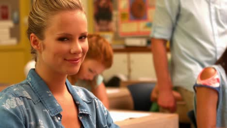 blonde student turning to smile at the camera