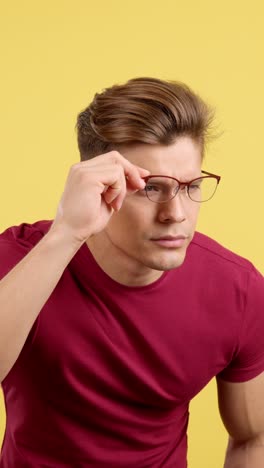 man with glasses adjusting and focusing on something