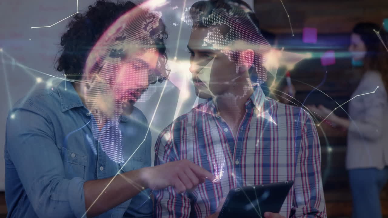 Two male colleagues reviewing tablet displaying holographic globe and network overlay for tech
