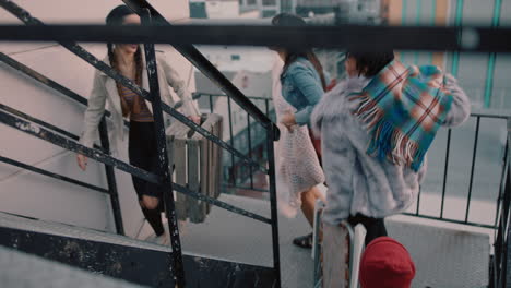 group of young multiracial friends walking up fire escape stairs ready for rooftop party chatting sharing excitement for weekend celebration