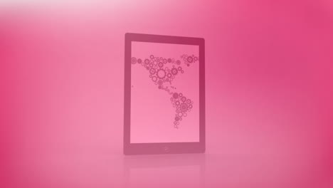 world map made of gears animation over pink tablet on pink background