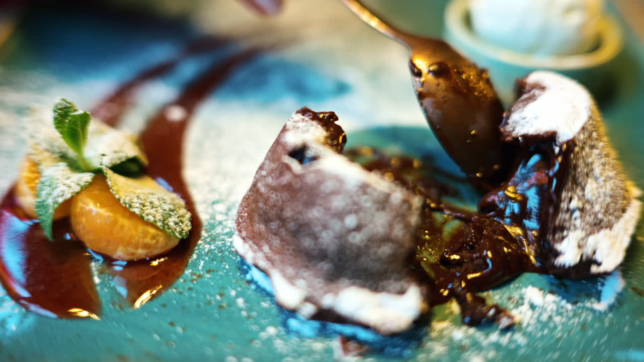 Chocolate lava cake with ice cream and orange decoration in a restaurant