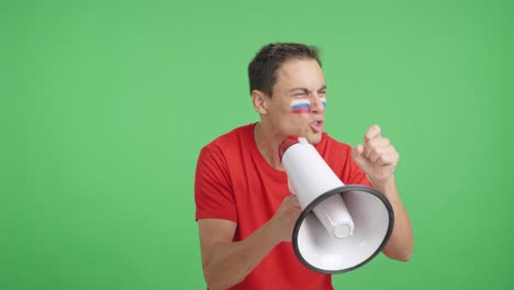 Excited man with russian flag on face using a megaphone