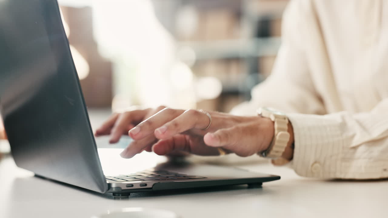 Close Up of Hands Typing on Laptop Keyboard