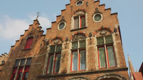 historic house with brick architecture and gable roof in bruges, belgium