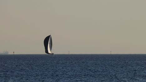 sailboat gliding across calm ocean waters