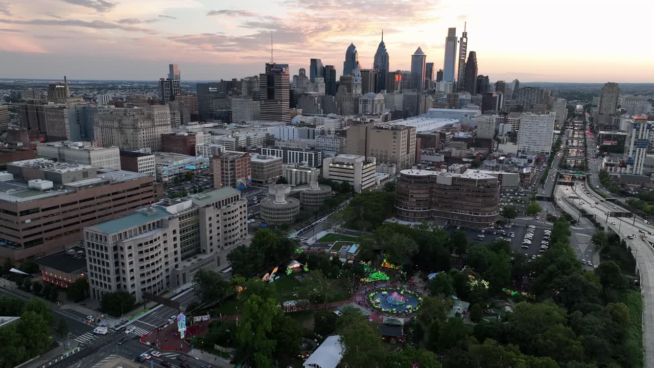 Franklin Square Park and traffic on expressway in downtown Philadelphia. Aerial wide shot. Sunset time with skyline skysceapers in distance. Pennsylvania, USA in summer