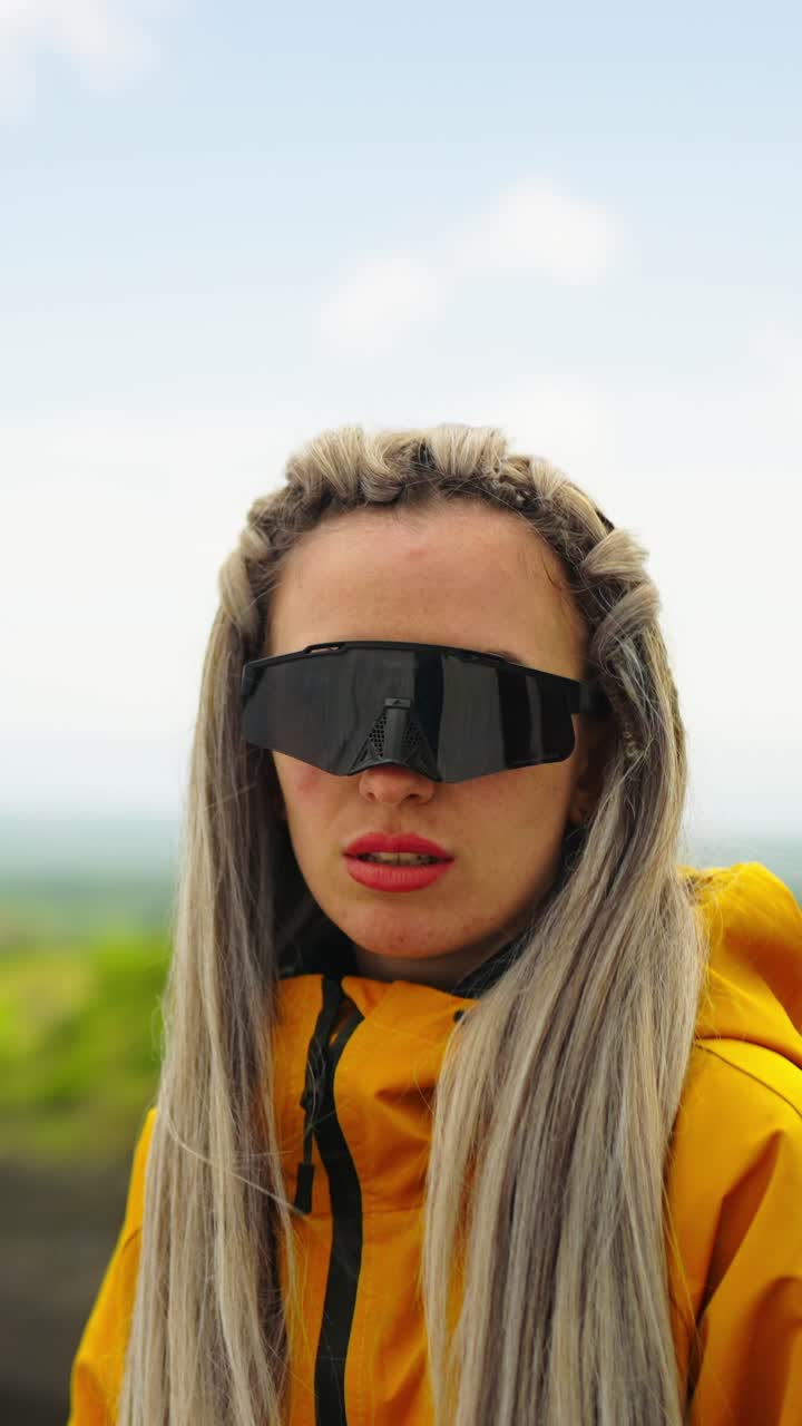 Young Woman with Blonde Hair and Sunglasses Posing Outdoors