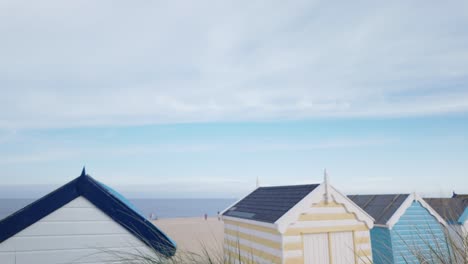 overlooking colourful beach huts at southwold seaside from sand dunes