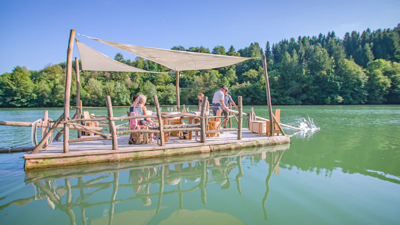 A family of visitors having a traditional Slovenian experience on a raft ride on Drava river