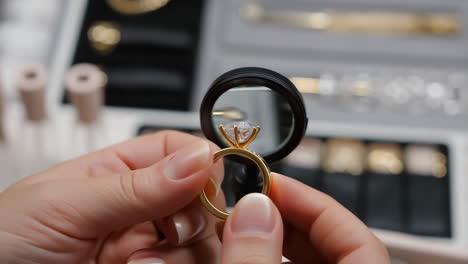 inspecting a diamond ring with a jeweler's loupe