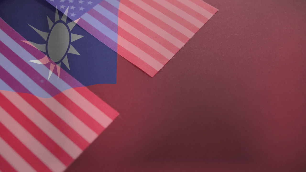 Overlapping Taiwan and United States flags symbolizing diplomacy on red background