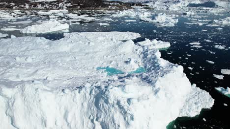 Floating-icebergs-in-ocean-near-Greenland,-aerial-view