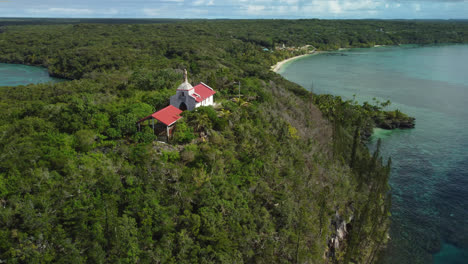 Aerial-arc-around-Chapelle-Notre-Dame-de-Lourdes-overlooking-bays-of-Jinek-and-Easo