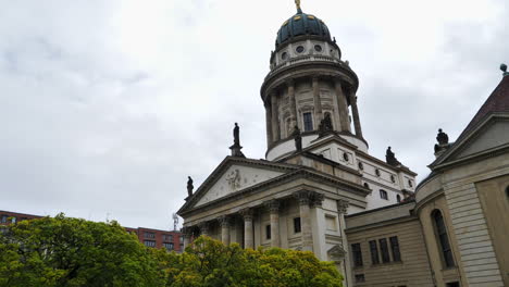 Tilt-up-shot-of-French-Cathedral-in-Berlin-on-cloudy-day,-Germany