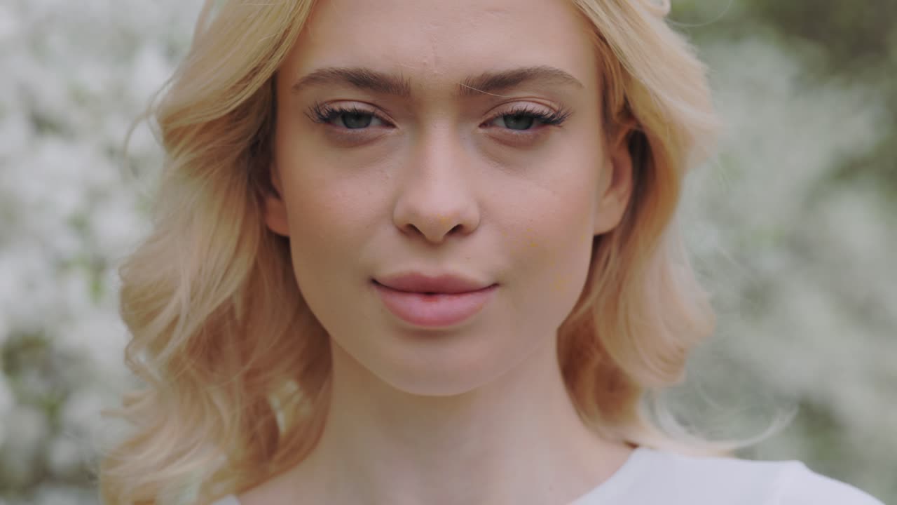 Blonde Woman Portrait in Spring Flowers